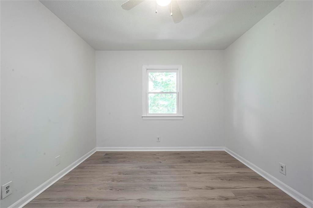 1752 Mitzi Court Duluth, GA 30097 - Photo 13 of 41 wooden floor in an empty room with a window