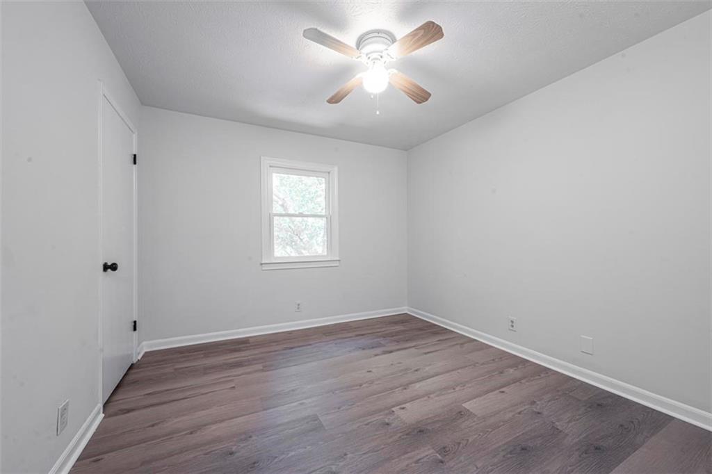 1752 Mitzi Court Duluth, GA 30097 - Photo 14 of 41 wooden floor in an empty room with a window