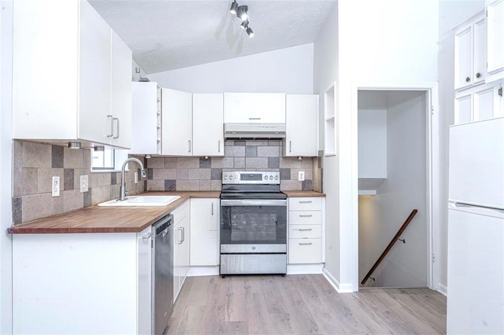 1752 Mitzi Court Duluth, GA 30097 - Photo 25 of 41 a kitchen with stainless steel appliances granite countertop a stove a refrigerator and a granite counter tops with wooden floors