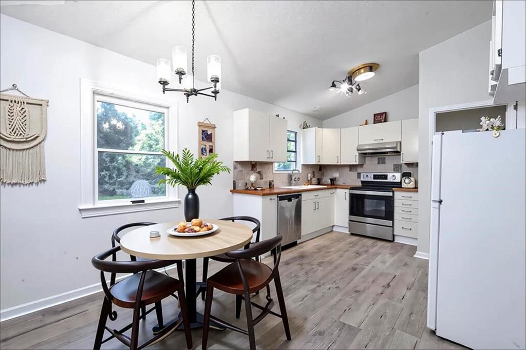 1752 Mitzi Court Duluth, GA 30097 - Photo 26 of 41 a kitchen with stainless steel appliances a dining table chairs and stove
