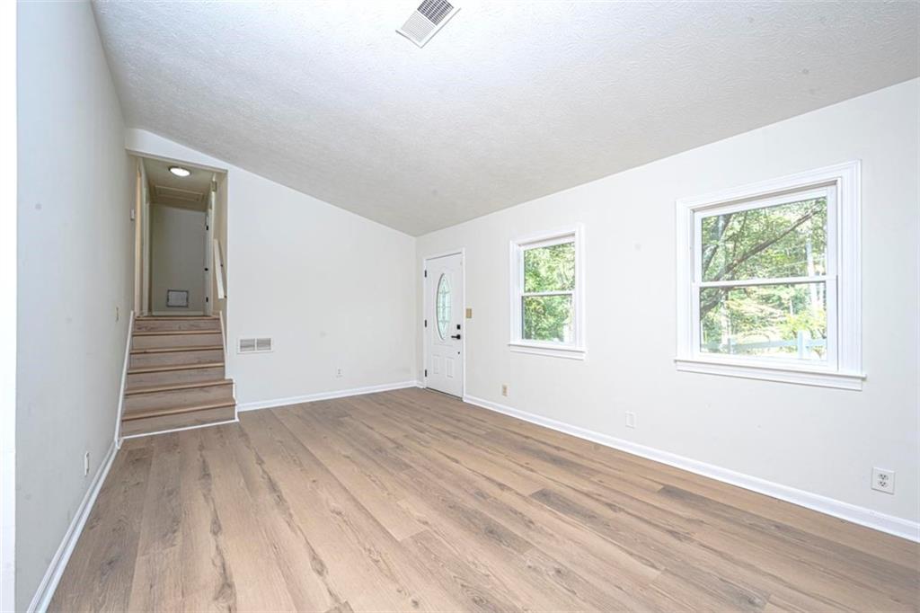 1752 Mitzi Court Duluth, GA 30097 - Photo 30 of 41 an empty room with wooden floor and windows