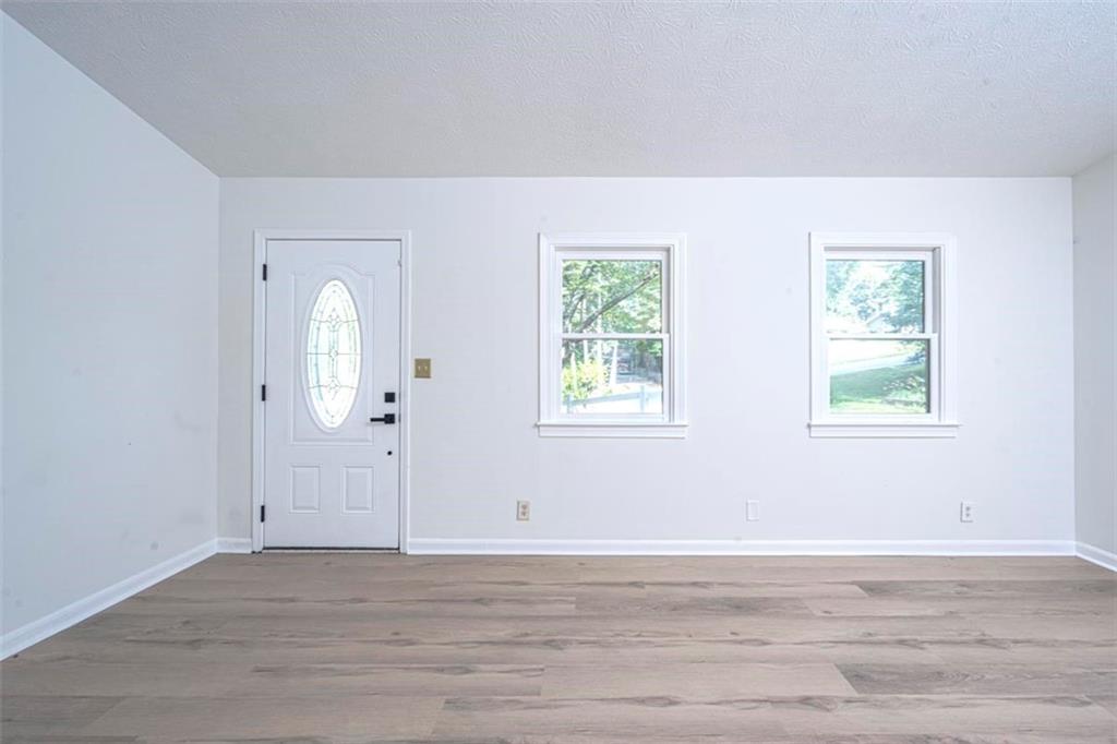 1752 Mitzi Court Duluth, GA 30097 - Photo 31 of 41 a view of an empty room with wooden floor and a window