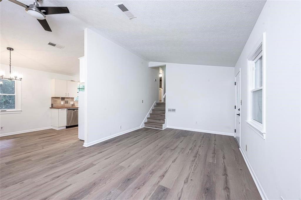 1752 Mitzi Court Duluth, GA 30097 - Photo 32 of 41 an empty room with wooden floor and windows