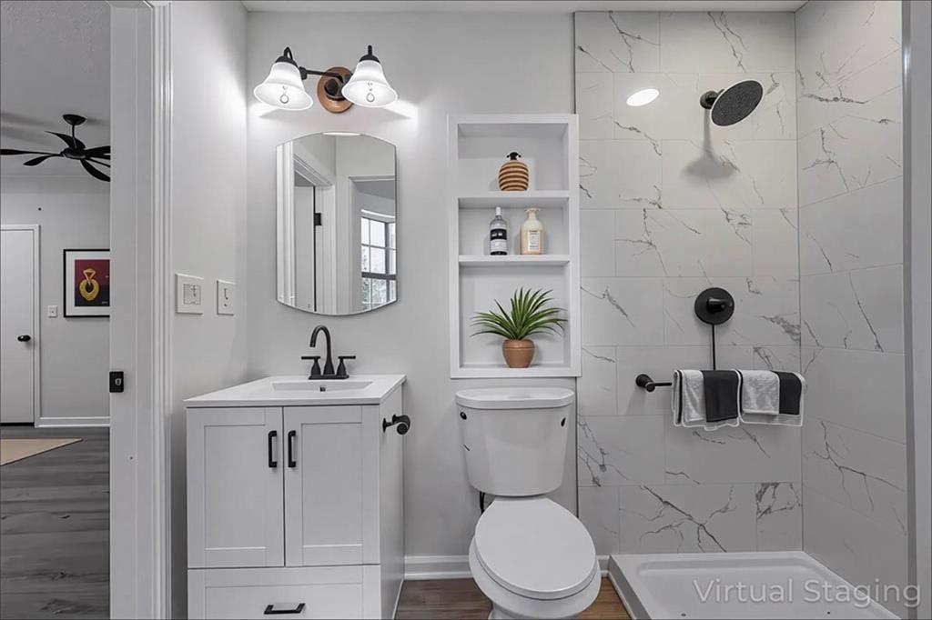 1752 Mitzi Court Duluth, GA 30097 - Photo 34 of 41 a bathroom with a toilet sink and mirror