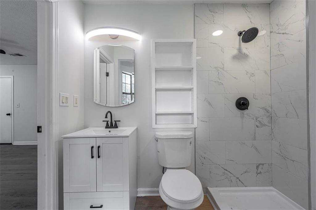 1752 Mitzi Court Duluth, GA 30097 - Photo 35 of 41 a bathroom with a sink a toilet and shower