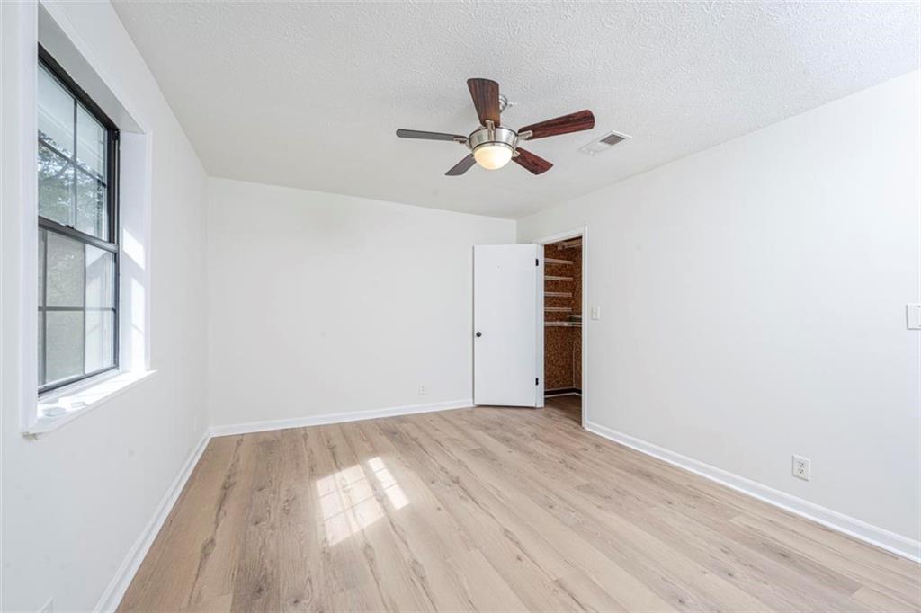 1752 Mitzi Court Duluth, GA 30097 - Photo 10 of 41 a view of empty room with wooden floor and fan