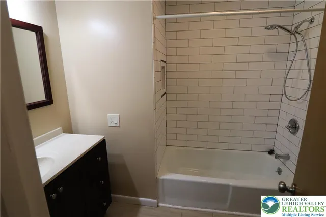 a bathroom with a bathtub sink and vanity