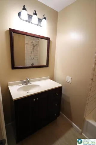 a bathroom with a sink and a mirror