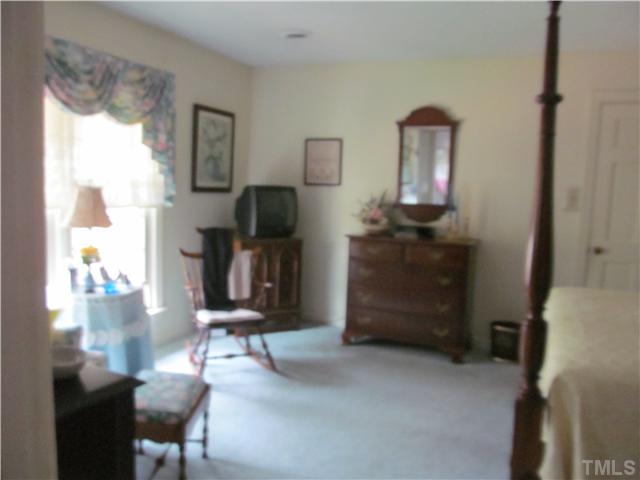 7420 Grist Mill Road Raleigh, NC 27615 - Photo 9 of 12 a room with furniture and a flat screen tv