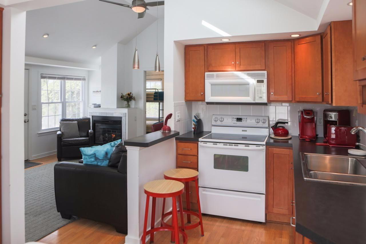 80 Bayview Road Eastham, MA 02642 - Photo 12 of 35 a kitchen with a stove a sink dishwasher and a refrigerator