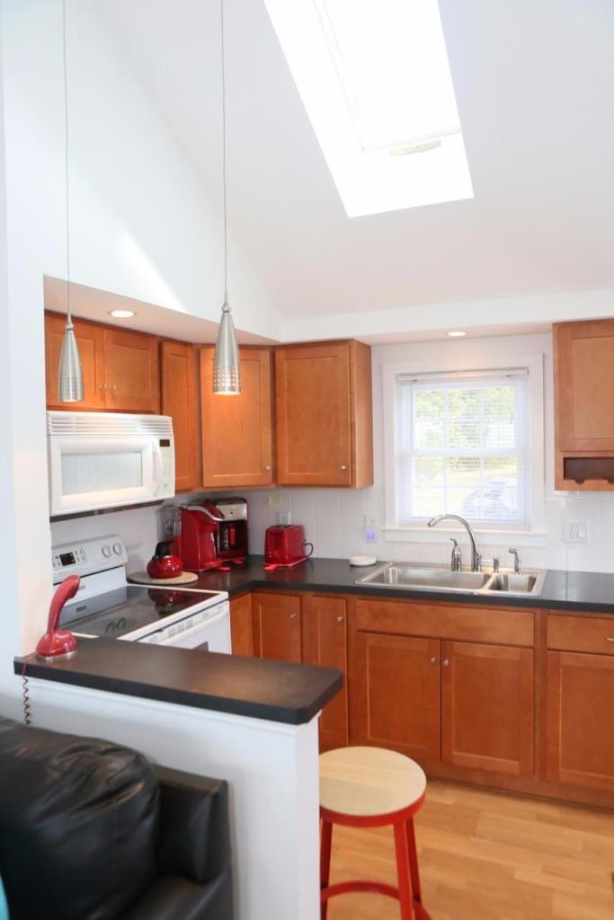 80 Bayview Road Eastham, MA 02642 - Photo 13 of 35 a kitchen with a sink a window and chairs