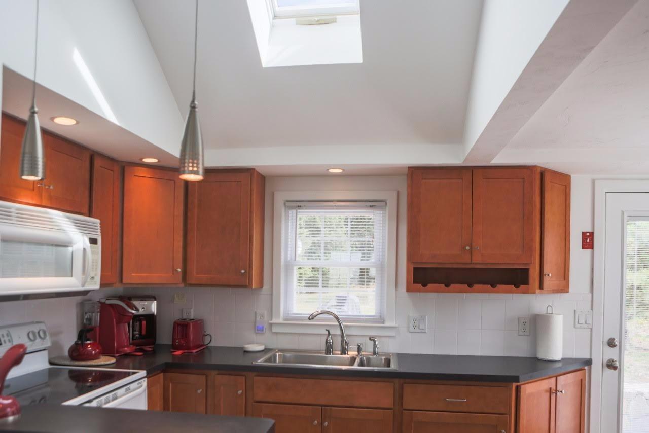 80 Bayview Road Eastham, MA 02642 - Photo 14 of 35 a kitchen with stainless steel appliances granite countertop a sink stove and cabinets