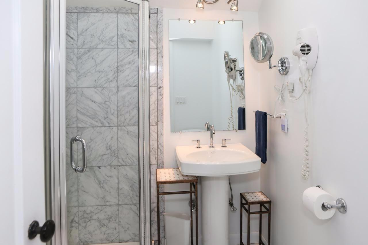 80 Bayview Road Eastham, MA 02642 - Photo 17 of 35 a bathroom with a sink a mirror and shower