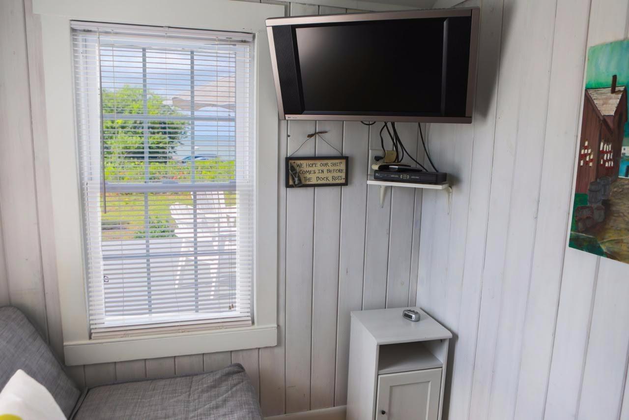 80 Bayview Road Eastham, MA 02642 - Photo 23 of 35 a living room with a flat screen tv and a window