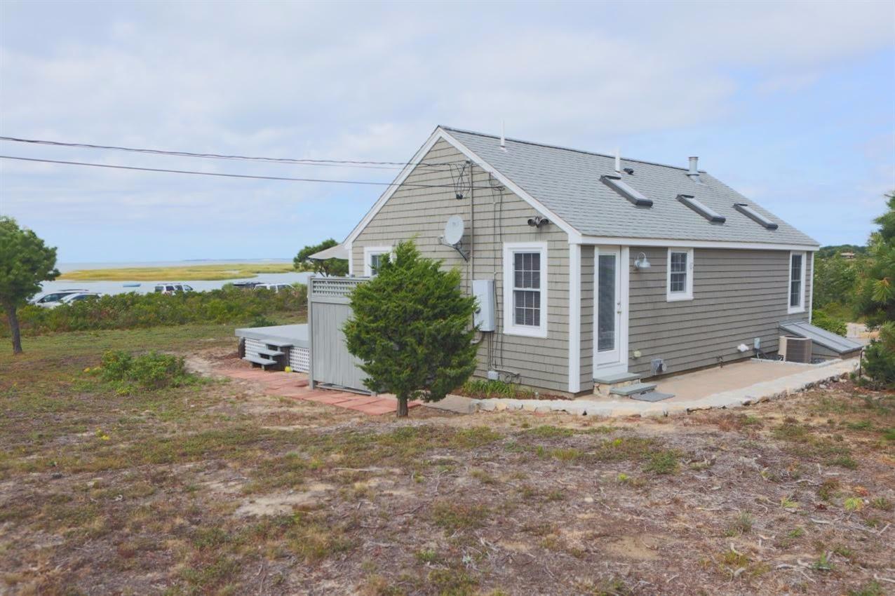 80 Bayview Road Eastham, MA 02642 - Photo 32 of 35 a view of a house with a yard and floor to ceiling window