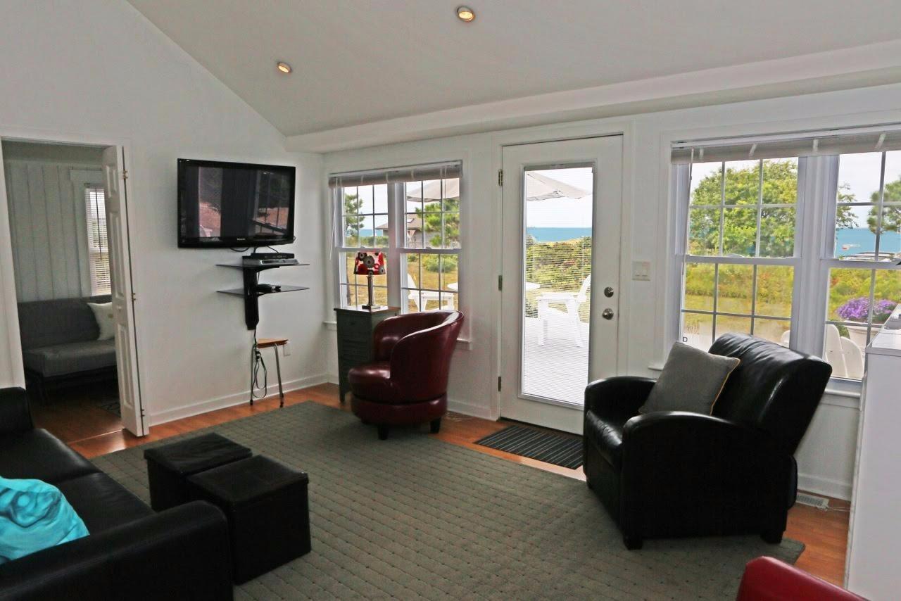 80 Bayview Road Eastham, MA 02642 - Photo 5 of 35 a living room with furniture and a flat screen tv