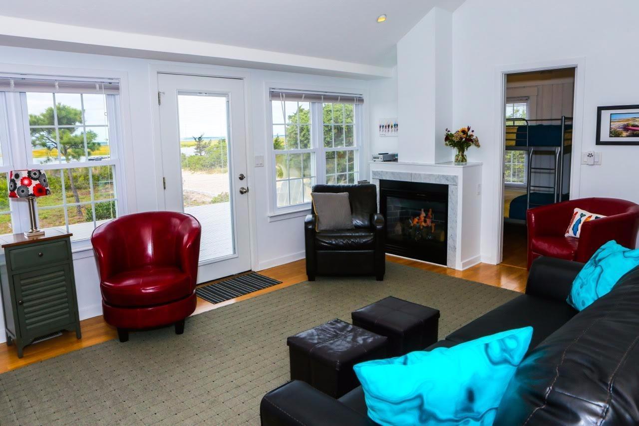 80 Bayview Road Eastham, MA 02642 - Photo 6 of 35 a living room with furniture fireplace and window