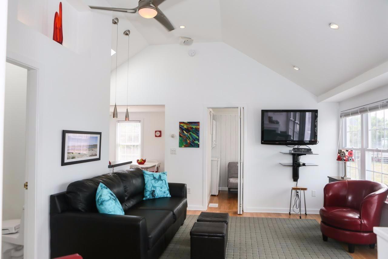 80 Bayview Road Eastham, MA 02642 - Photo 10 of 35 a living room with furniture and a flat screen tv