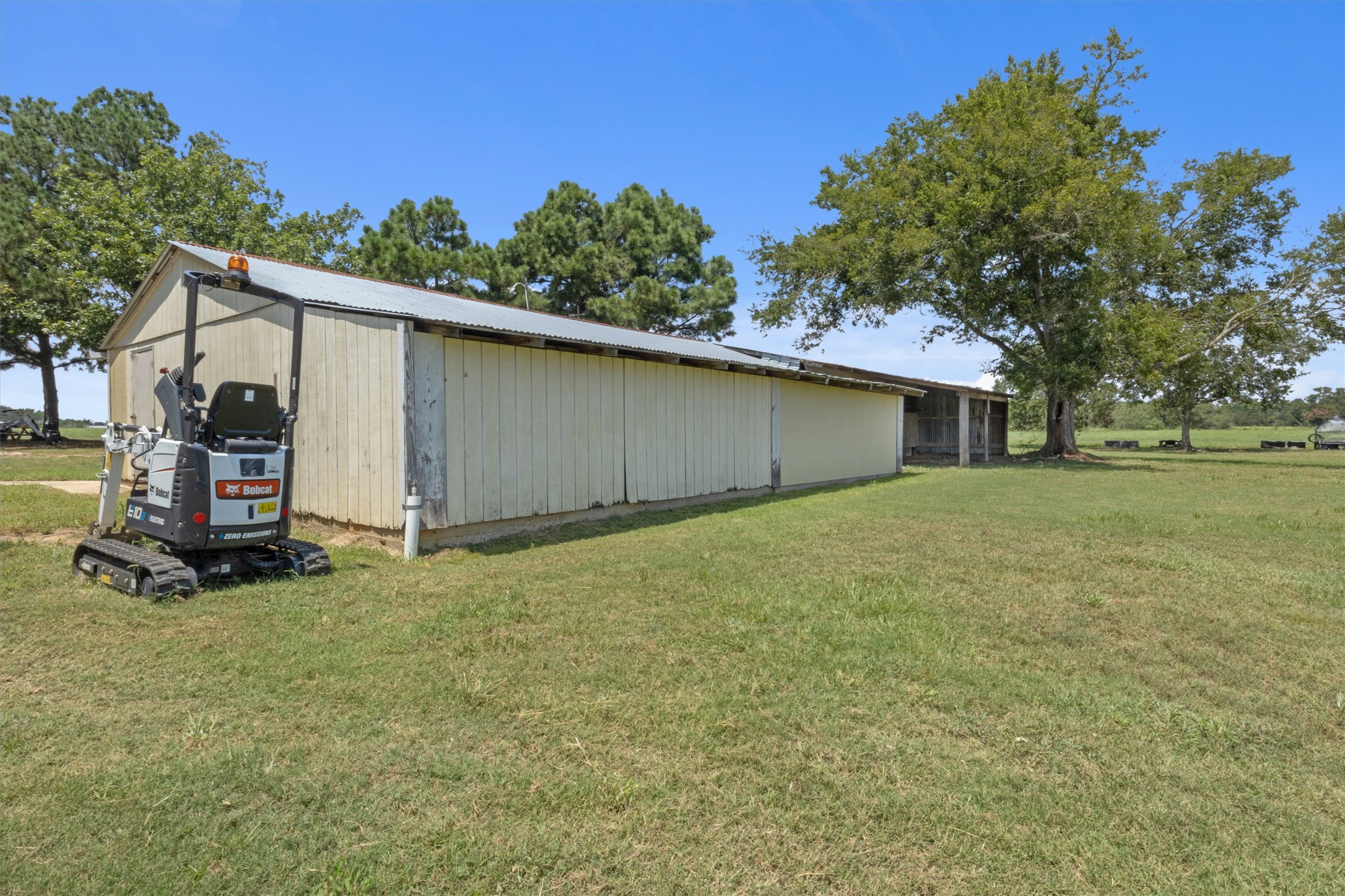 451 Pleasant Grove Road Elgin, TX 78621 - Photo 17 of 26 View of pole building with a lawn