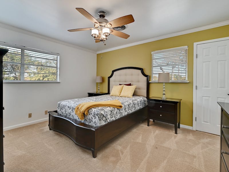 1802 Temple Drive Austin, TX 78721 - Photo 14 of 20 Bedroom with light carpet, crown molding, and ceiling fan