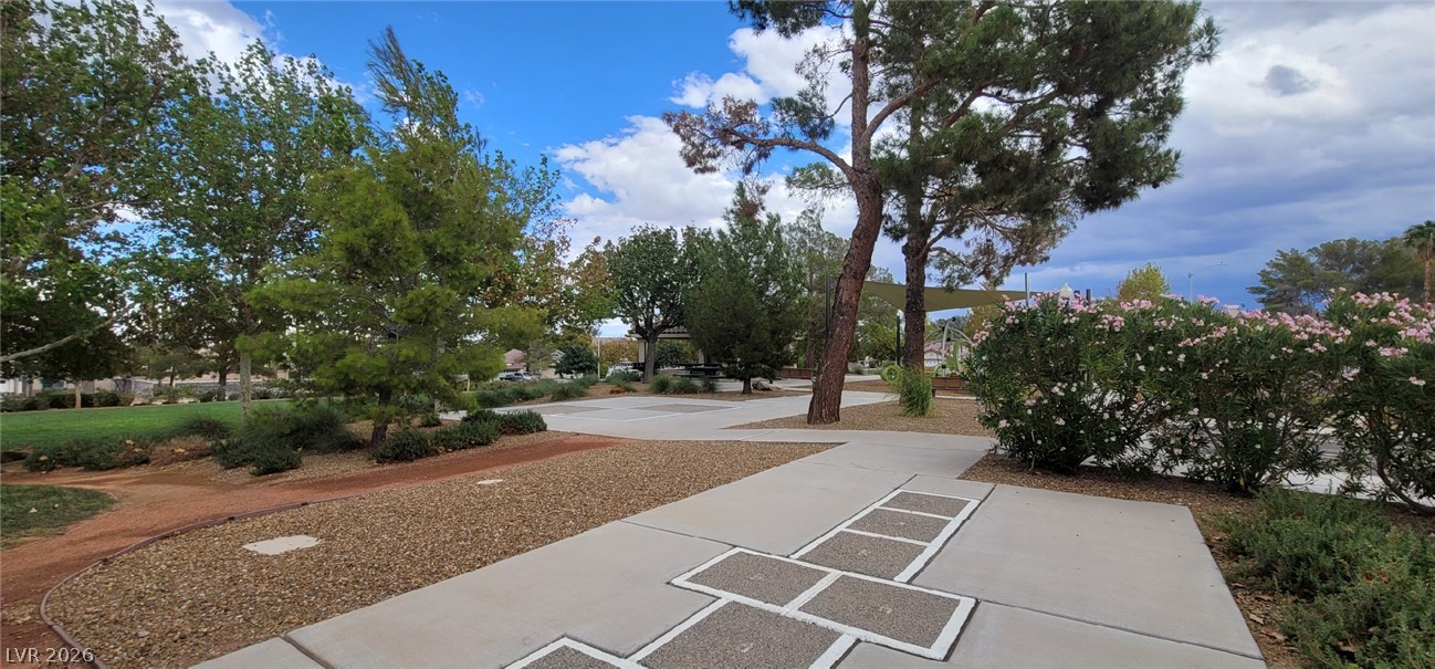 19 Rue De Parc Henderson, NV 89074 - Photo 21 of 23 Paved walkways wind through beautifully landscaped community grounds beneath towering mature trees.