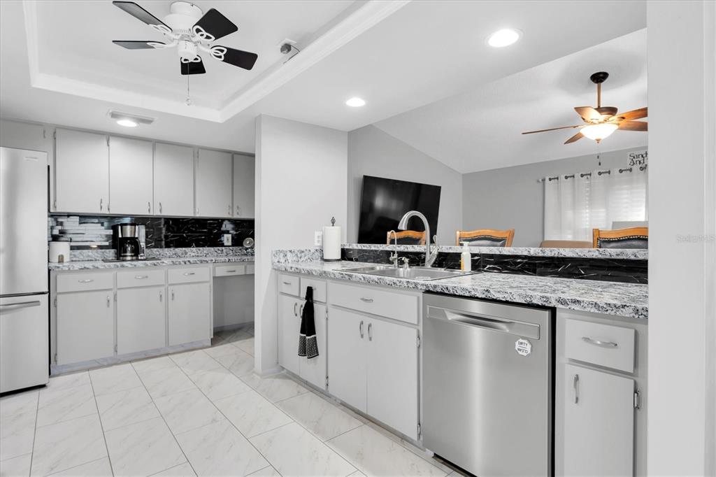 7099 Pond View Court Spring Hill, FL 34606 - Photo 12 of 64 a kitchen with appliances cabinets and a sink