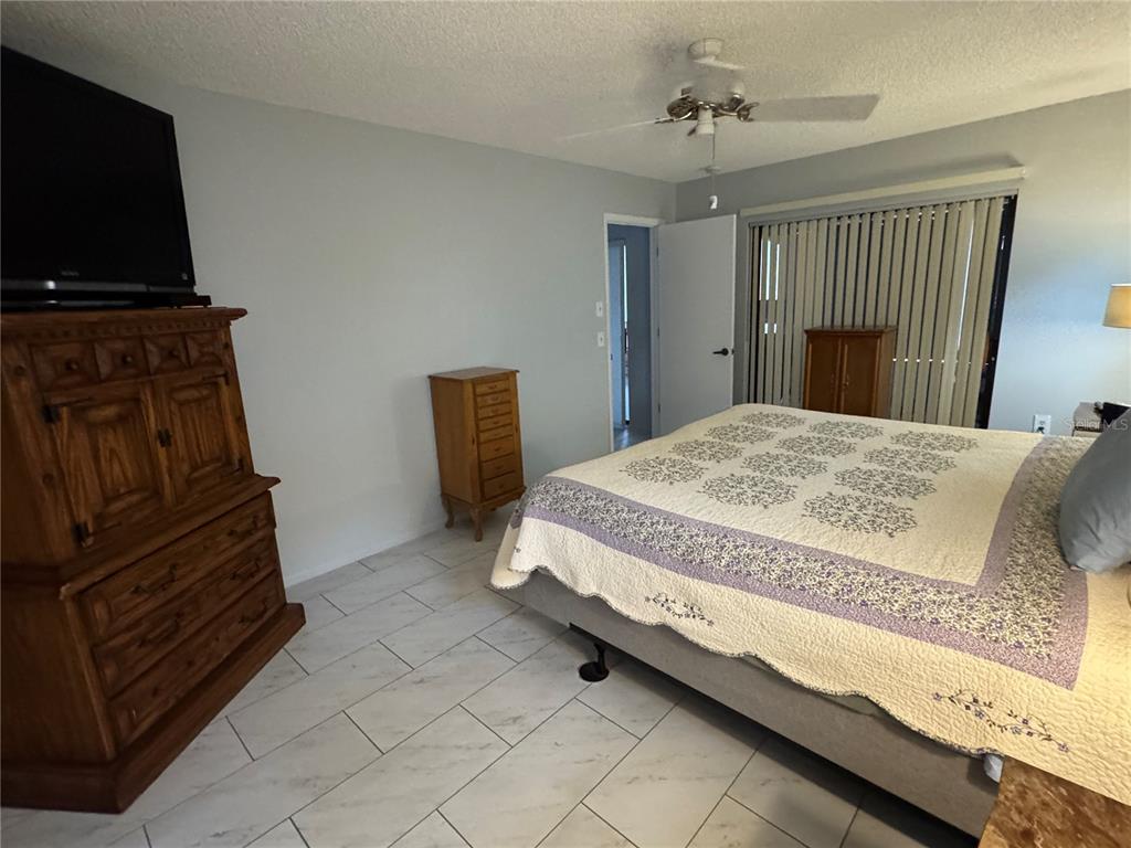 7099 Pond View Court Spring Hill, FL 34606 - Photo 22 of 64 a bedroom with a bed and a television