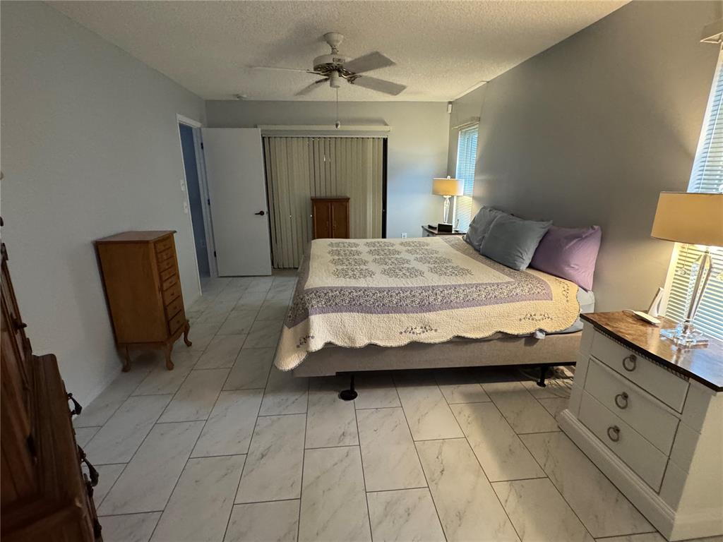 7099 Pond View Court Spring Hill, FL 34606 - Photo 24 of 64 a bedroom with a bed and a mirror on dresser