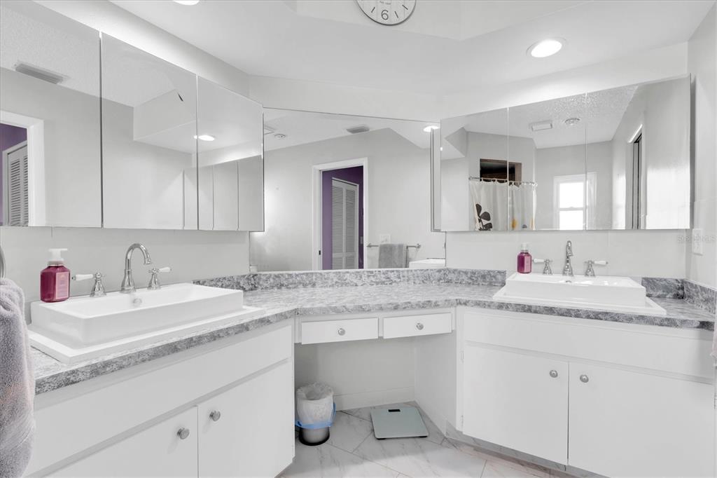 7099 Pond View Court Spring Hill, FL 34606 - Photo 25 of 64 a bathroom with a granite countertop sink double and mirror