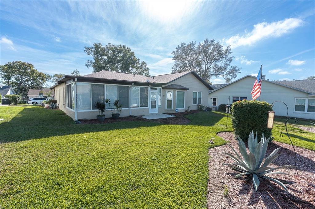 7099 Pond View Court Spring Hill, FL 34606 - Photo 35 of 64 a front view of house with yard and seating area