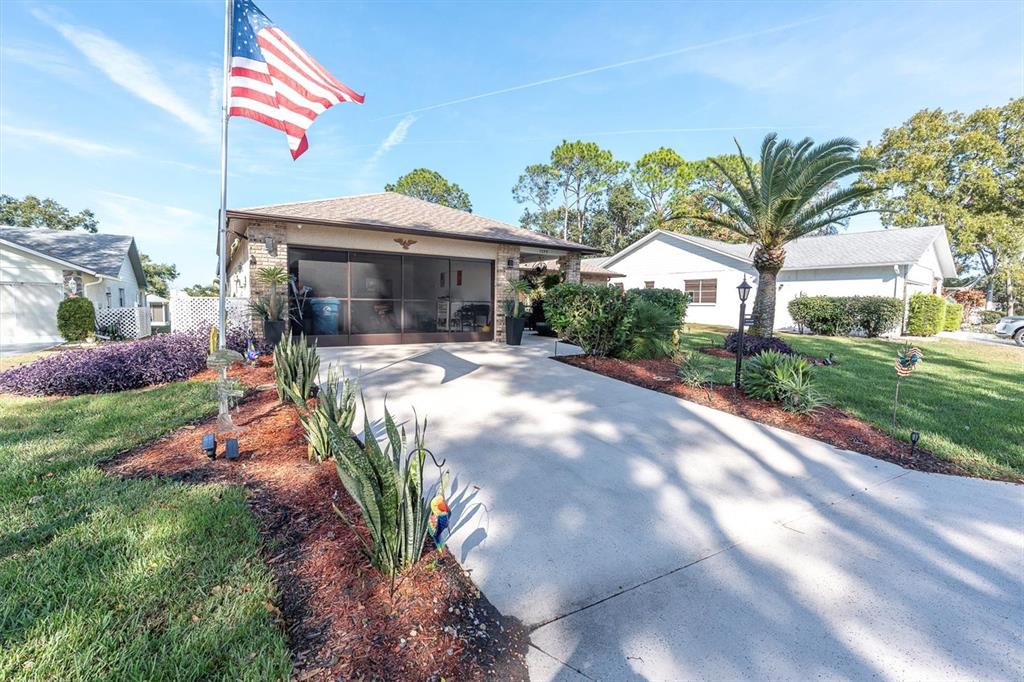 7099 Pond View Court Spring Hill, FL 34606 - Photo 37 of 64 a view of a house with a yard and potted plants