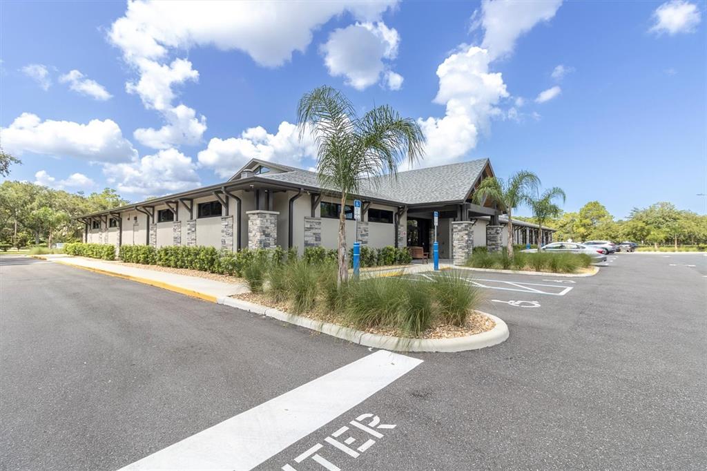7099 Pond View Court Spring Hill, FL 34606 - Photo 53 of 64 a front view of a house with a yard and lake view