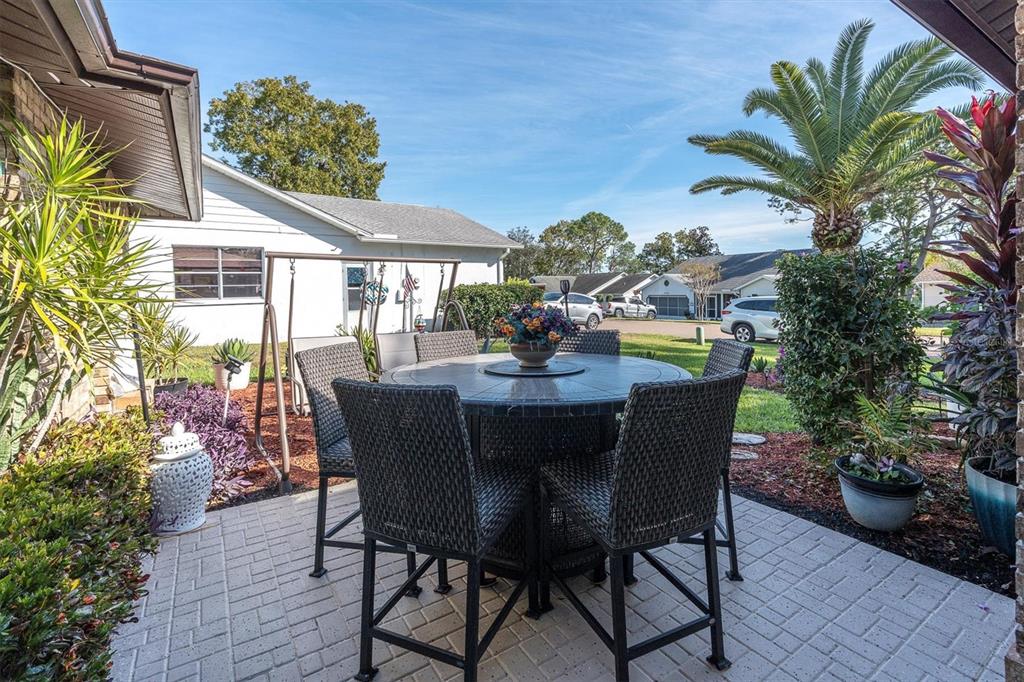 7099 Pond View Court Spring Hill, FL 34606 - Photo 6 of 64 a view of a dining table and chairs in patio