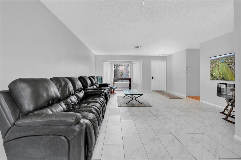 7099 Pond View Court Spring Hill, FL 34606 - Photo 9 of 64 a view of a livingroom with a couch and a couch