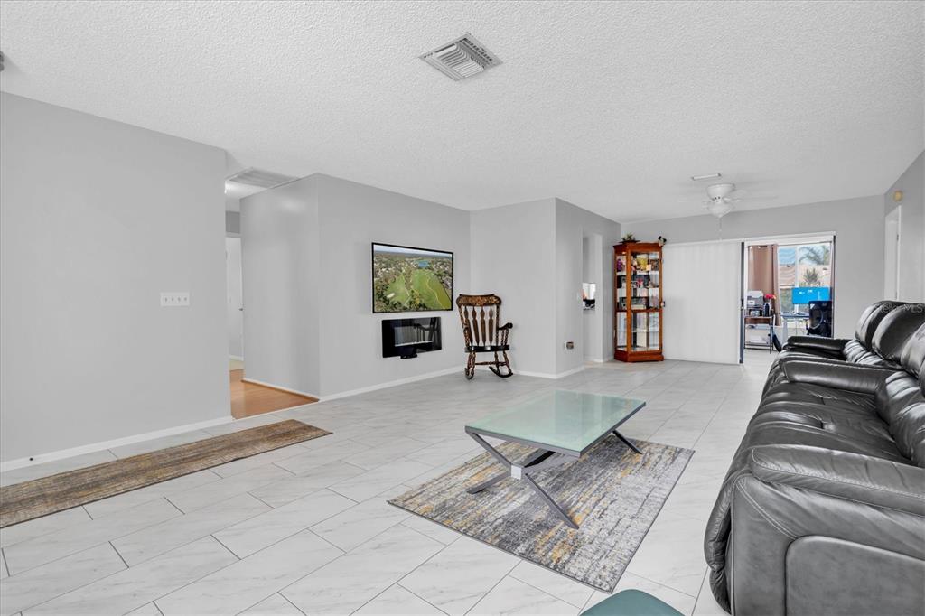7099 Pond View Court Spring Hill, FL 34606 - Photo 10 of 64 a living room with furniture and a couch