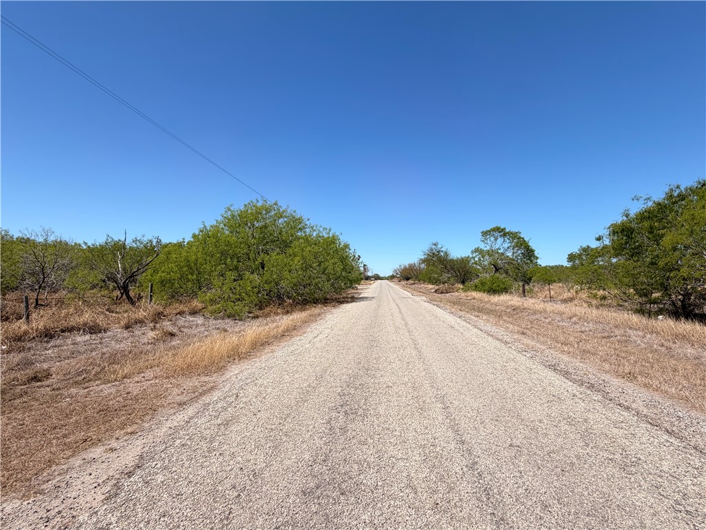 0 La Paloma Road Bishop, TX 78343 - Photo 5 of 6 a view of a road with a building in the background