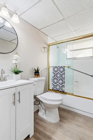 a bathroom with a sink mirror vanity and toilet