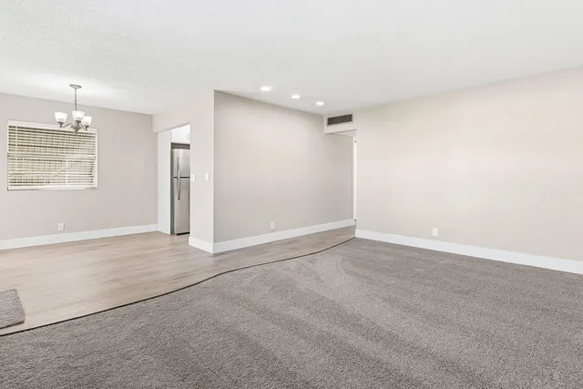 an empty room with a empty space and windows