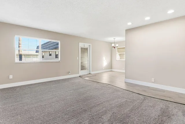 an empty room with windows and closet