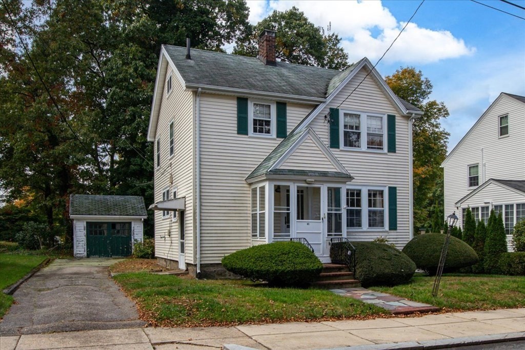 41 Bogandale Road Boston, MA 02132 - Photo 2 of 38 a front view of a house with a yard and garage