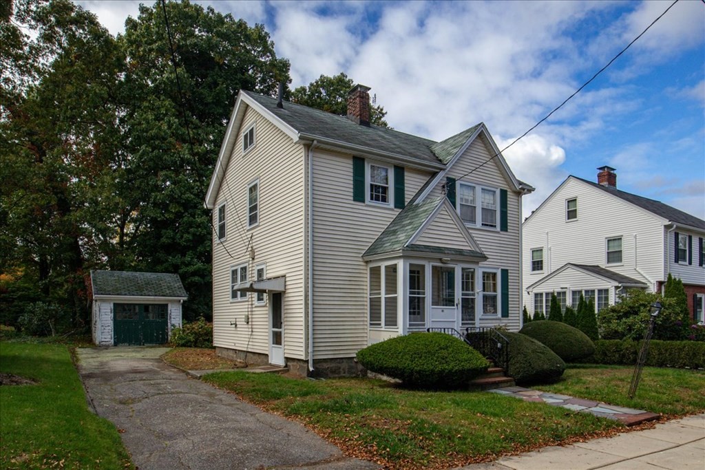 41 Bogandale Road Boston, MA 02132 - Photo 35 of 38 a front view of a house with a yard and garage