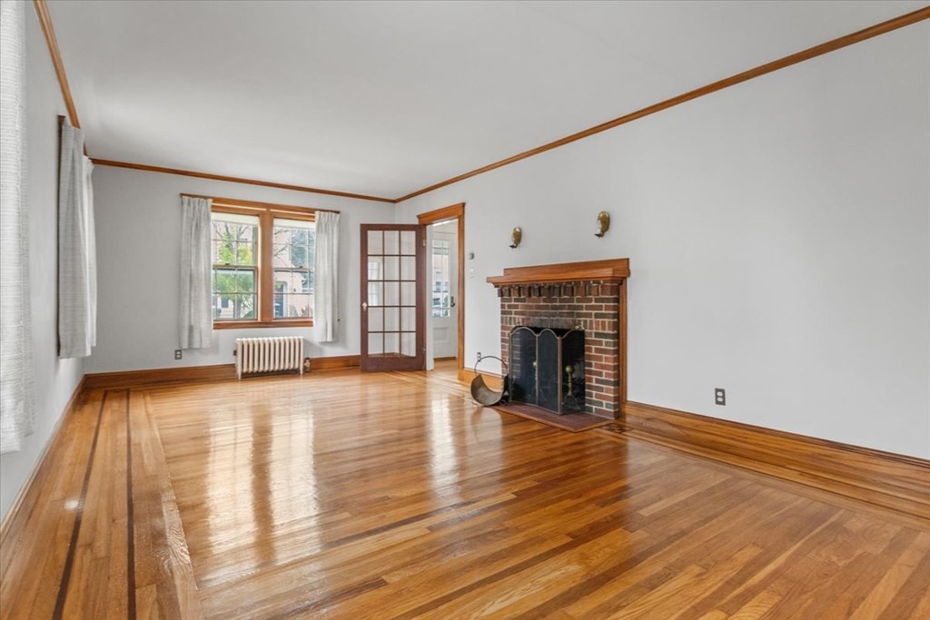 41 Bogandale Road Boston, MA 02132 - Photo 7 of 38 a view of an empty room with wooden floor and a window