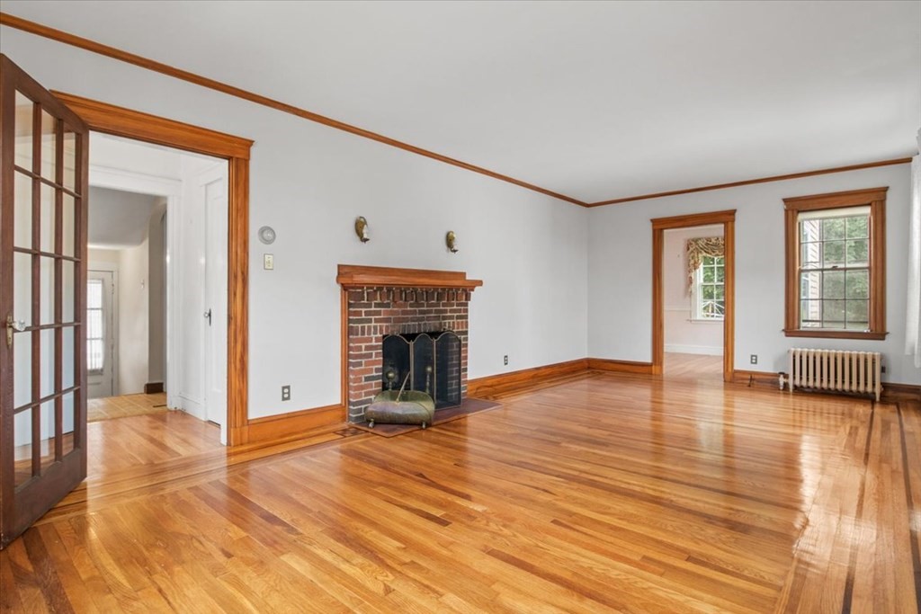 41 Bogandale Road Boston, MA 02132 - Photo 8 of 38 a view of empty room with wooden floor and fireplace