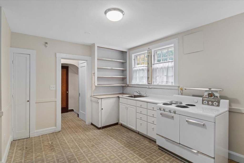 41 Bogandale Road Boston, MA 02132 - Photo 9 of 38 a kitchen with stainless steel appliances granite countertop a stove a sink and a refrigerator