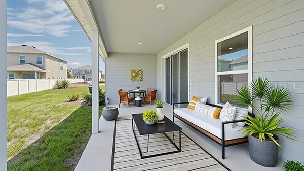 a living room with patio furniture and a patio