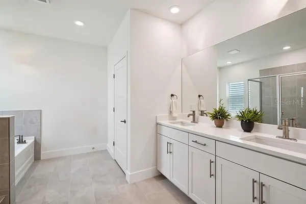 a bathroom with double sink and a mirror