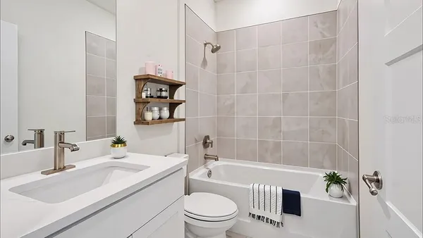 a bathroom with a sink a toilet and a bathtub