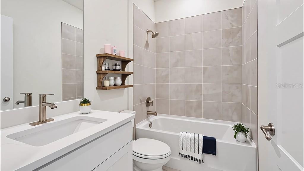 3963 Southwest 54th St Road Ocala, FL 34474 - Photo 9 of 24 a bathroom with a sink a toilet and a bathtub