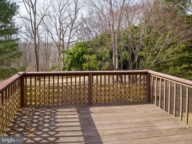 a view of balcony with wooden floor and fence