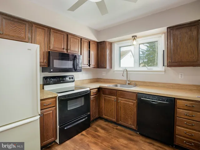 a kitchen with a sink stove and microwave